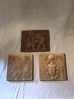 Group shot of three ceramic relief panels