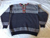 Full front view of navy and white patterned Norlender wool sweater