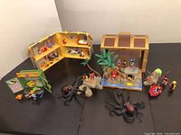 All three Playmobil carry-along sets displayed open with figures and accessories