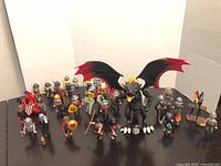 Group shot showing dragon, knights, horses and accessories