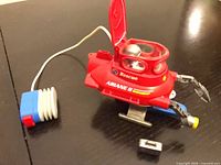 Side view of red Playmobil 3064 Rescue Submarine with air-pump tether and small loose part