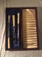 Open case showing knife, fork, steel in blue satin lining