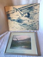 Both artworks together: framed rowing watercolour and unframed blue swimmer print