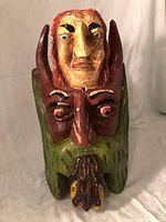 Front view of painted wooden dual-face mask