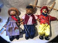 All three marionettes laid out showing full bodies and controllers