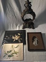 Group shot showing all four items: clock case, two prints, photo