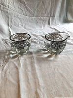 Sugar bowl and creamer front view, silver overlay visible