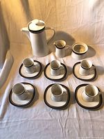 Full set showing coffee pot, creamer, sugar bowl, four cups on saucers