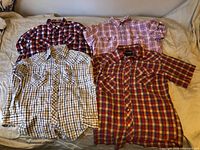 All four plaid western shirts laid out showing fronts