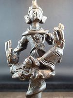 Front close-up of bronze Thai Buddhist statue on spiral base