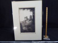 Full view of framed etching with ruler for scale