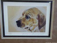 Close-up of print showing yellow lab puppy, edition number, title, and artist signature.