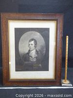 Full view of framed portrait with measuring stick for scale