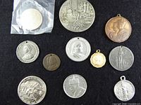 Group shot of all medals laying on black cloth