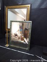 Both mirrors standing, gold frame behind, green frame in front