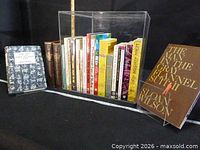 Entire lot of books shown upright and separated from two additional titles