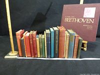 Full lot of 18 books with measuring tape and Beethoven volume on stand
