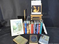 Group shot of approximately 20 books including hardcovers, paperbacks and display copies