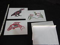 Front view of three art cards and three envelopes, ruler for scale