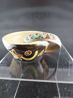 Hand-painted ceramic bowl showing exterior decoration and handle