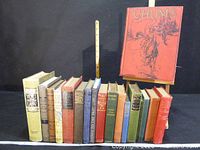 Full group of cloth-bound books on shelf with CHUMS annual displayed