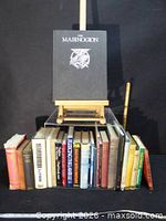 Full lot overview showing The Mabinogion on easel above row of books