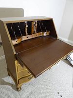 Desk open showing interior pigeonholes and writing surface