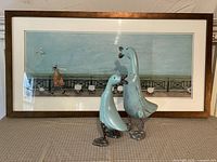 Framed Sam Toft print with both wooden ducks displayed in front