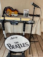 Full lot showing guitar, game case, microphone, drum front plate