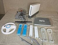 Console, remotes, nunchuks, wheel, sensor bar, power and A/V cables, manual