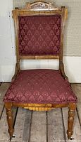 Front view of carved Eastlake chair with burgundy upholstery