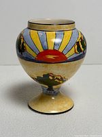 Full view of vase front showing sunset design and form