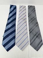 Three Armani silk neckties displayed flat