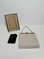 Group shot of frame, purse and wallet