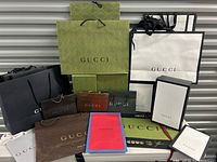 Front view of all Gucci shopping bags and boxes