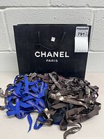 Full lot view: Chanel shopping bag and assorted designer ribbons