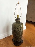 Full view of ceramic lamp on wooden base