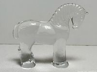 Full side view of clear glass horse figurine