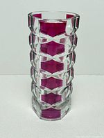 Full view of faceted clear glass vase with magenta panels