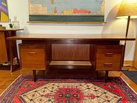 Front view of teak executive desk showing twin drawer pedestals and kneehole