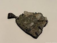 Front view of pendant showing pyrite and quartz cluster in sterling silver setting