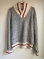 Front view of grey shawl collar Roots sweater showing overall design and trim