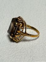 Side profile of ring showing basket setting and band