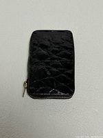 Front view of black patent leather key wallet