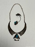 Necklace and ear clip front view showing design, stones, and metal