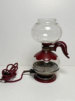 Full view of glass coffee maker with cord