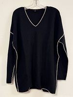Front view of black V-neck sweater with white piping
