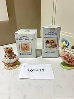 Both figurines with their boxes and lot card visible