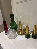 Group shot of all six decorative glass and brass pieces