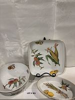 Square dish with peaches and corn motif on stand, gold rim visible